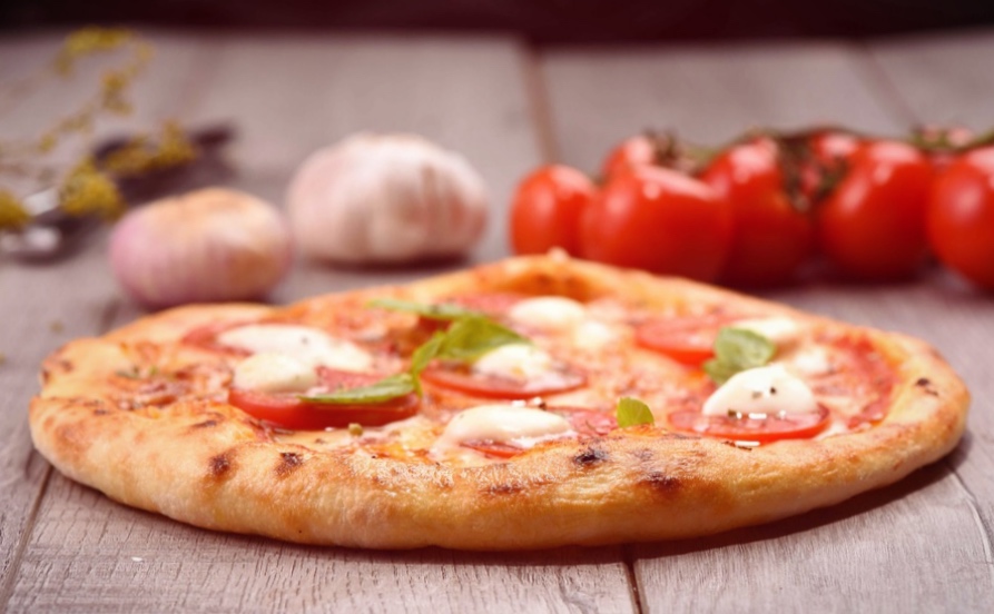 Margherita pizza with fresh tomato and a potato-based dough 