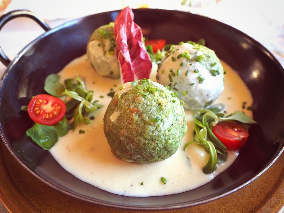 Spinach and potato balls in gorgonzola sauce