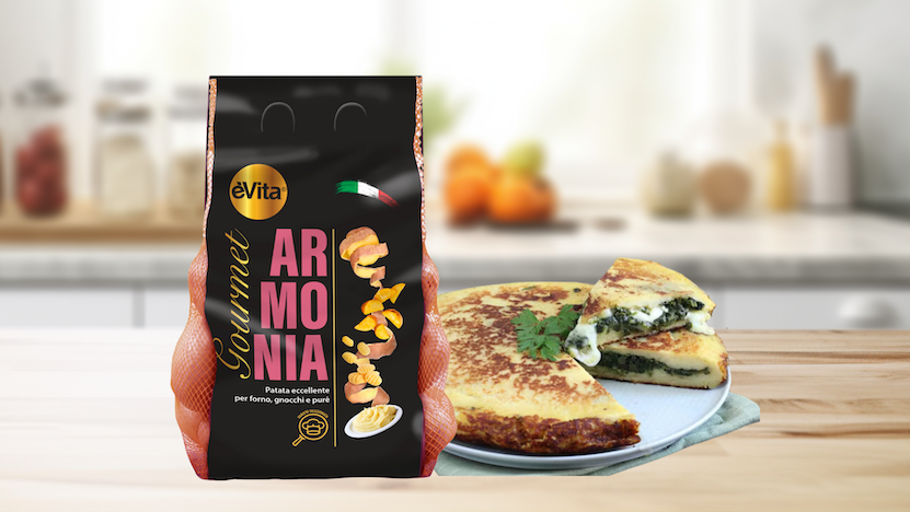 Potato cake in a frying pan with spinach and mozzarella cheese