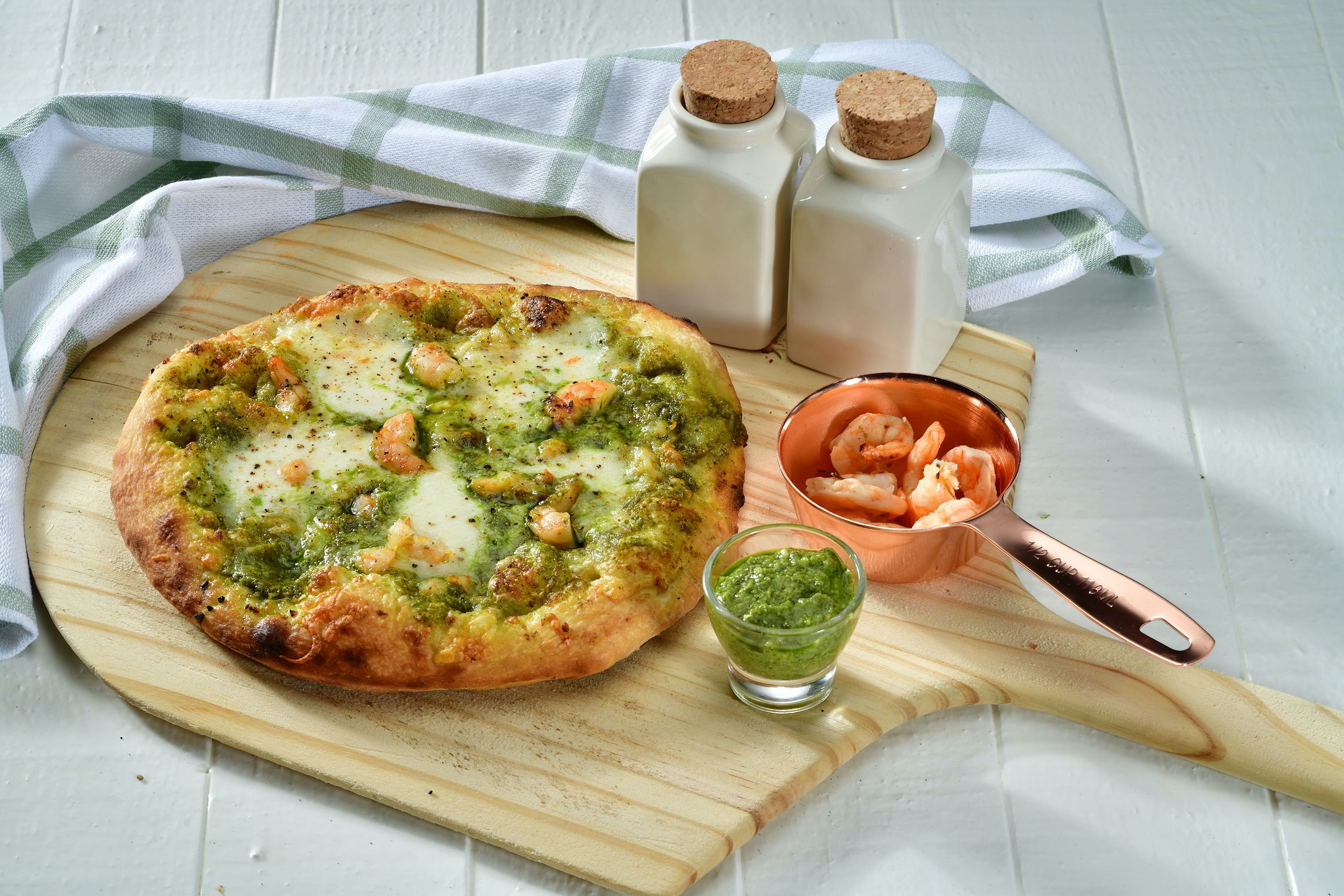 Potato pizza with basil pesto and baby prawns